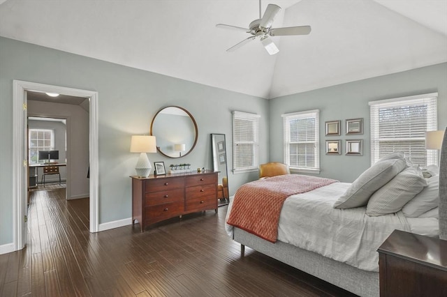 bedroom featuring baseboards, wood finished floors, and multiple windows