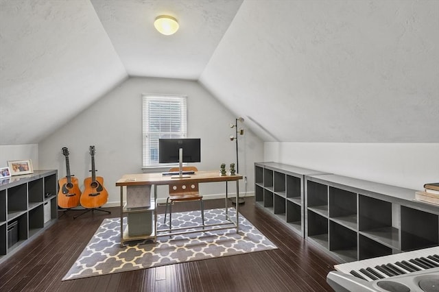 office space with baseboards, dark wood-style floors, and lofted ceiling