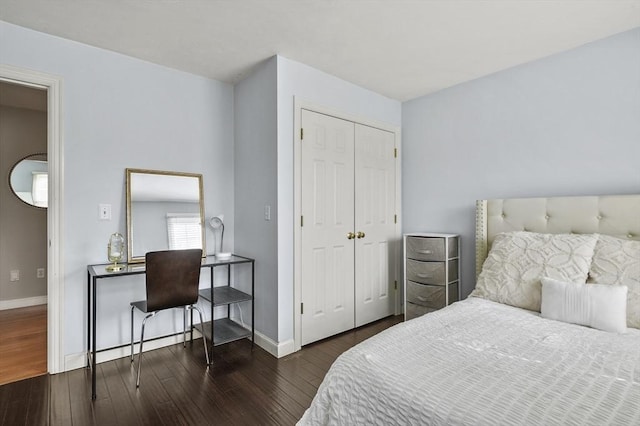 bedroom with baseboards, a closet, and hardwood / wood-style flooring