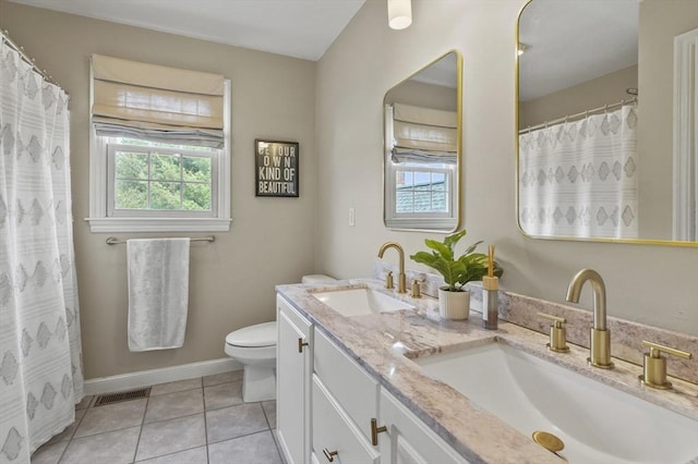 full bathroom featuring toilet, tile patterned floors, visible vents, and a sink