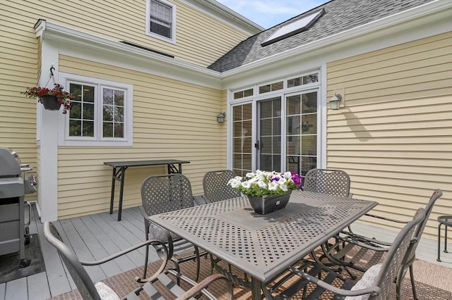 wooden terrace with outdoor dining area