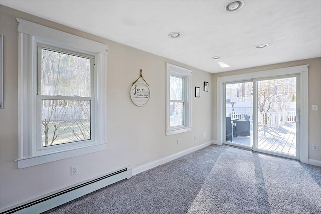 unfurnished room featuring baseboards, baseboard heating, and carpet floors