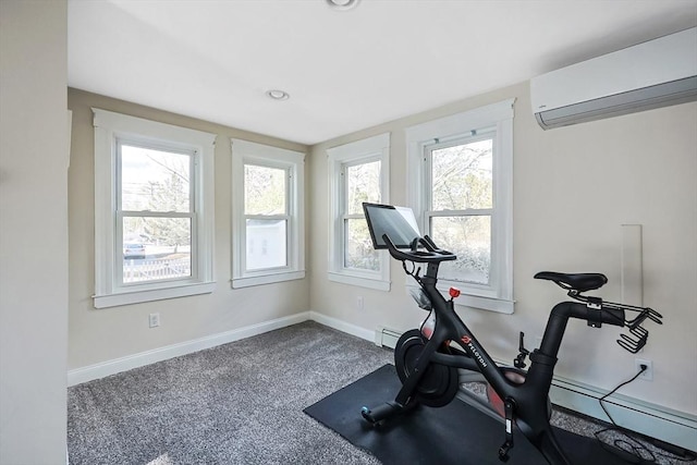 workout room featuring baseboard heating, a wall mounted air conditioner, baseboards, and carpet floors