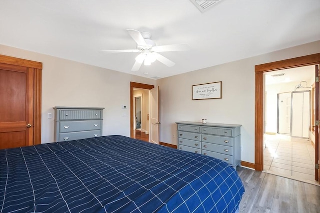 unfurnished bedroom featuring visible vents, baseboards, a ceiling fan, and wood finished floors