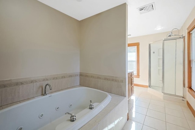 bathroom featuring visible vents, a shower stall, baseboards, a whirlpool tub, and tile patterned floors