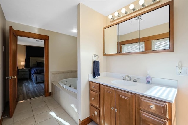 full bath with visible vents, a garden tub, ensuite bathroom, tile patterned flooring, and vanity