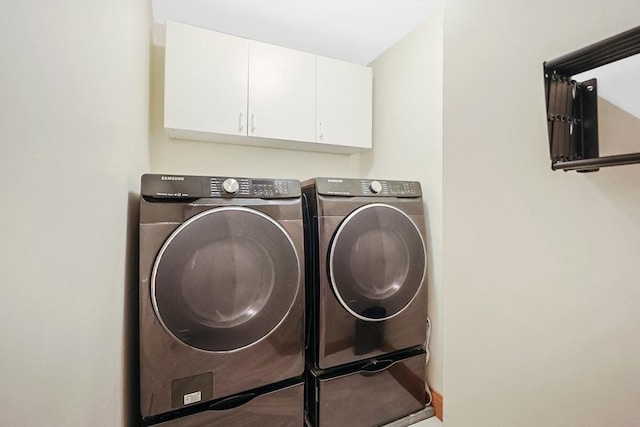 laundry room featuring washer and dryer and cabinet space