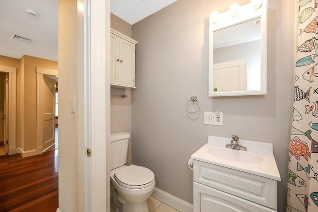 full bath featuring visible vents, toilet, wood finished floors, baseboards, and vanity