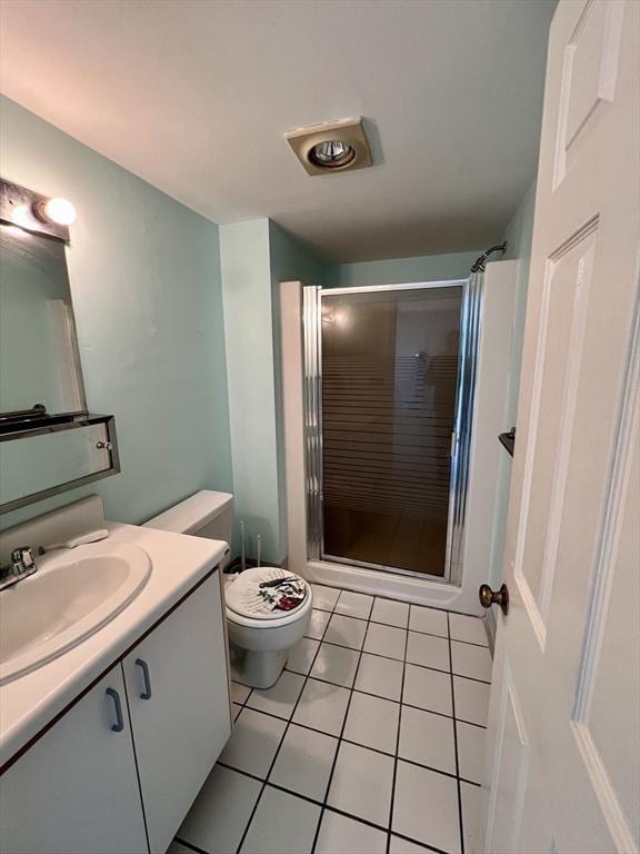 bathroom with walk in shower, tile patterned flooring, vanity, and toilet