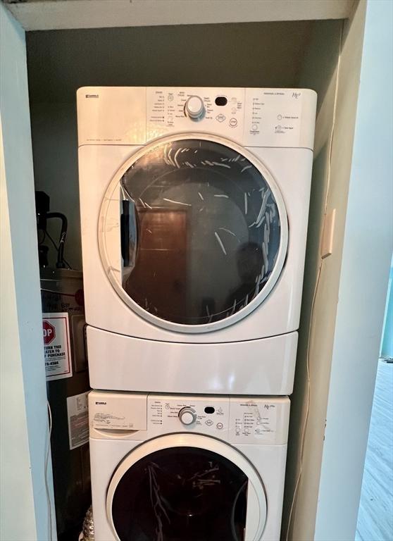 laundry room featuring stacked washer / drying machine