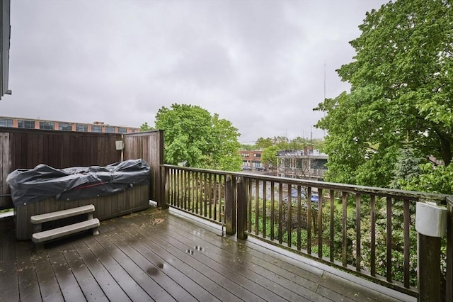 wooden terrace featuring a hot tub
