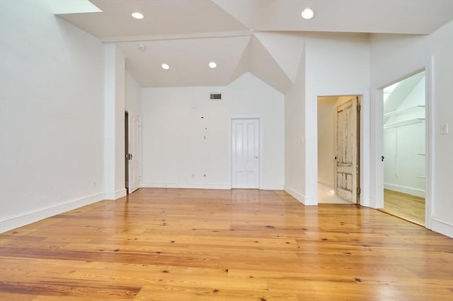 unfurnished living room featuring light wood-style floors, recessed lighting, baseboards, and vaulted ceiling