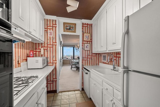 85 E India Row Unit 18B, Boston, MA 02110 - kitchen with white appliances, wallpapered walls, light countertops, white cabinetry, and light colored carpet