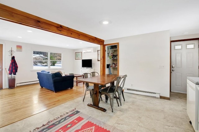 dining room with a baseboard heating unit, a wall unit AC, and beamed ceiling