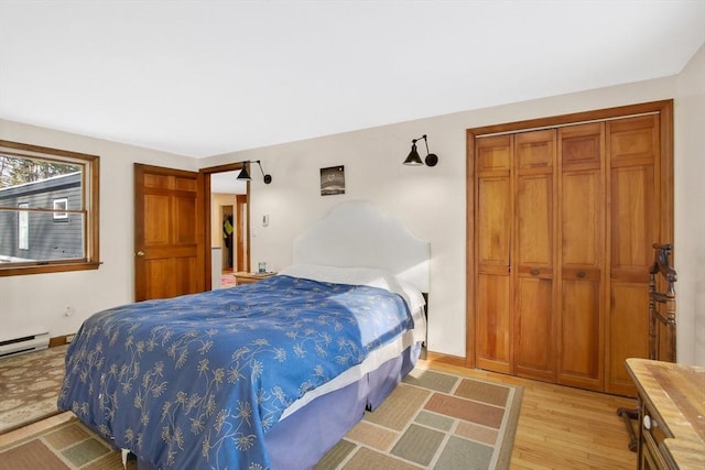 bedroom with light wood-type flooring and a closet