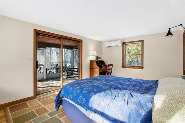 bedroom featuring access to outside and a wall unit AC