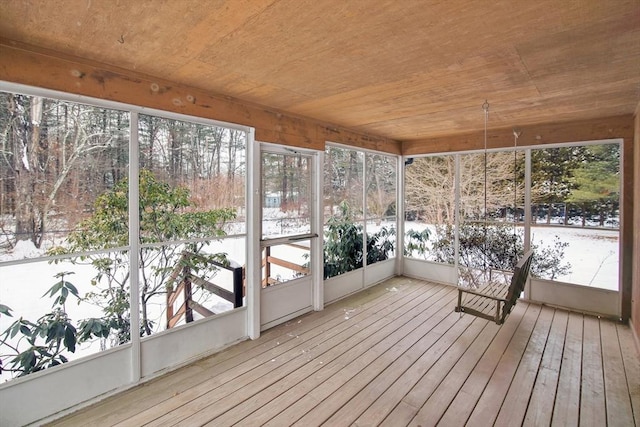 unfurnished sunroom with a wealth of natural light and wood ceiling