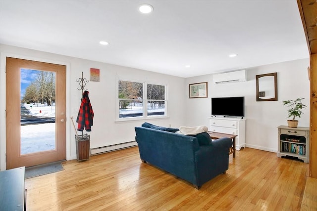 living room with a baseboard radiator, a wall mounted air conditioner, and light hardwood / wood-style flooring