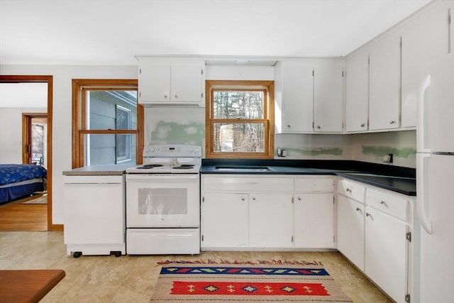 kitchen featuring white cabinetry and white appliances