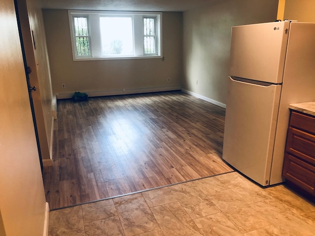 interior space featuring light hardwood / wood-style flooring and stainless steel fridge