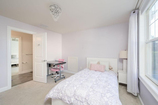 bedroom featuring baseboards, light carpet, and visible vents