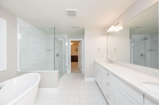 bathroom featuring a stall shower, a sink, double vanity, a soaking tub, and a spacious closet