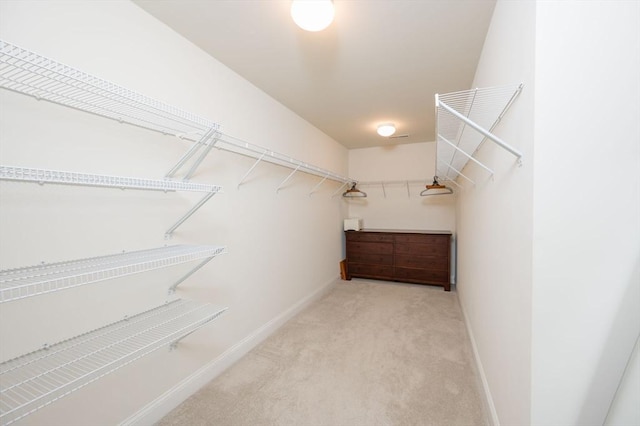 spacious closet with carpet flooring