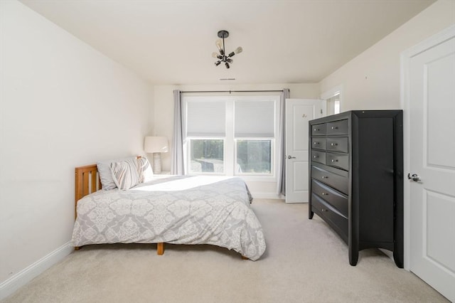 bedroom with baseboards and light carpet