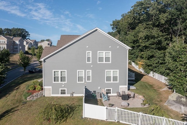 rear view of property with a patio area, a lawn, and a fenced backyard