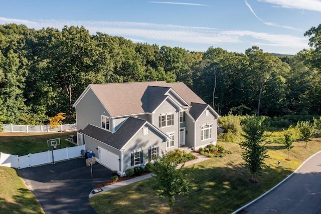 birds eye view of property featuring a view of trees