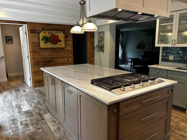 16 Pinehurst Ave, Dracut, MA 01826 - kitchen featuring stainless steel gas cooktop, ventilation hood, glass insert cabinets, dark wood-style flooring, and pendant lighting