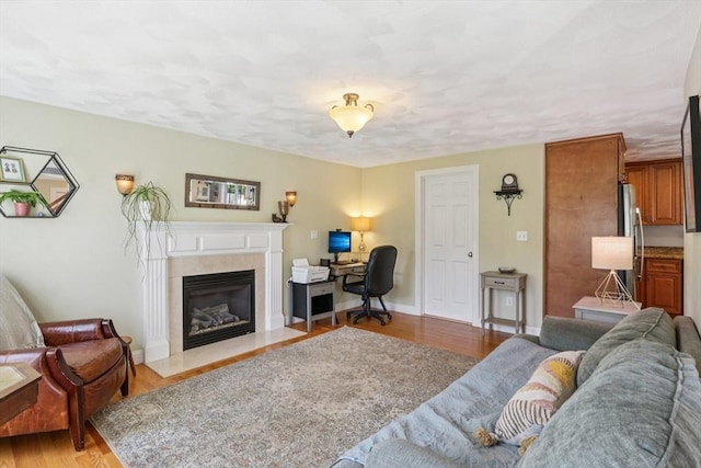 3 Trophy Ave, Townsend, MA 01469 - living room featuring a fireplace with flush hearth, light wood-type flooring, an office area, and baseboards
