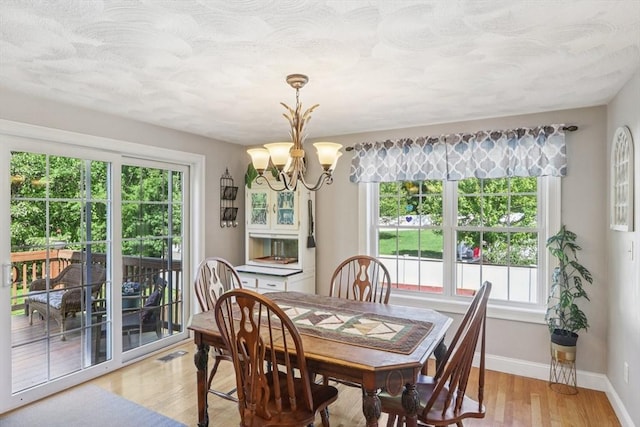 3 Trophy Ave, Townsend, MA 01469 - dining room with a chandelier, light wood finished floors, and baseboards