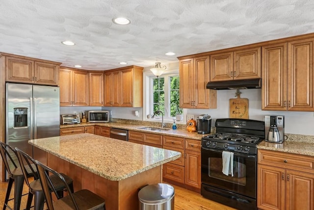 3 Trophy Ave, Townsend, MA 01469 - kitchen with stainless steel appliances, under cabinet range hood, a sink, brown cabinetry, and recessed lighting