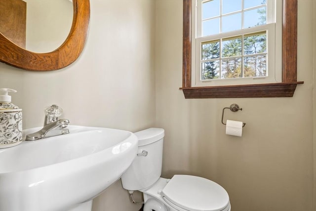 half bath with toilet and a sink
