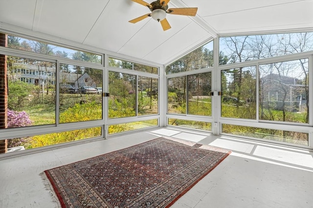 unfurnished sunroom featuring ceiling fan