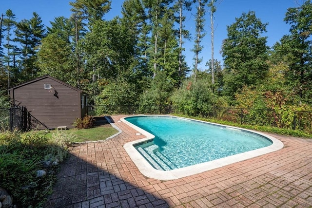 view of pool featuring a fenced in pool, fence, an outdoor structure, and a patio area