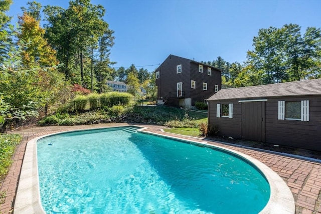 view of swimming pool with a fenced in pool, an outdoor structure, and fence