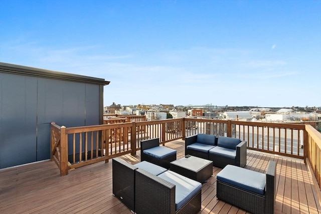 wooden terrace with an outdoor living space