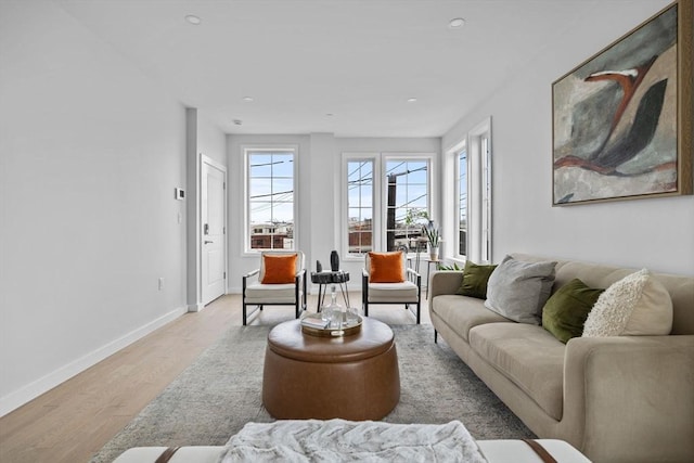 living room with recessed lighting, a healthy amount of sunlight, baseboards, and wood finished floors