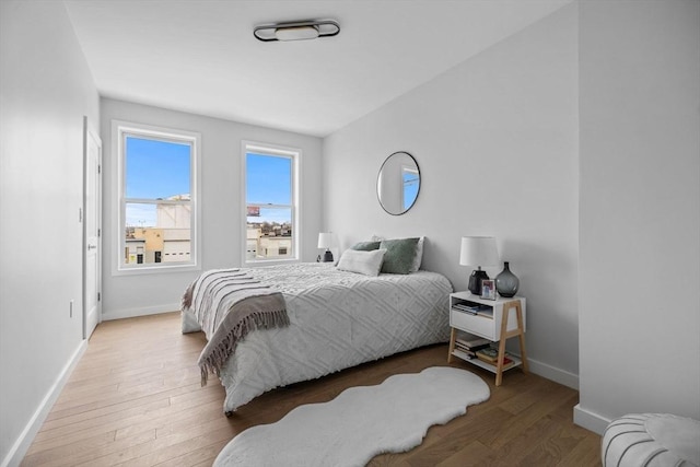 bedroom featuring baseboards and wood finished floors