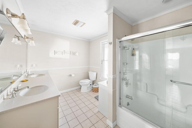 bathroom featuring toilet, tile patterned flooring, ornamental molding, and a sink