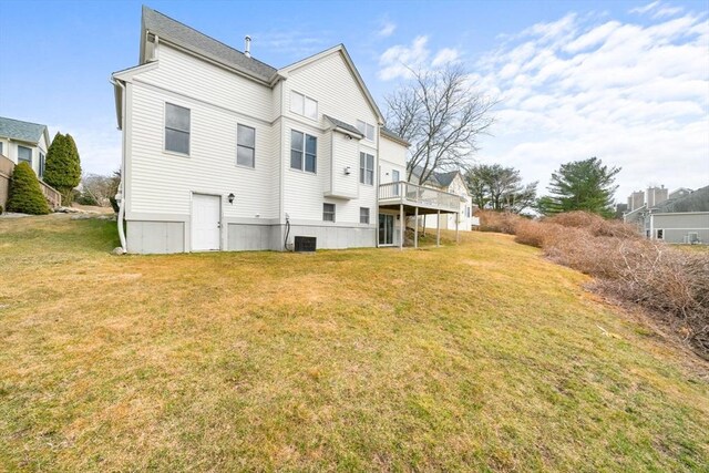 rear view of property with central AC, a lawn, and a wooden deck