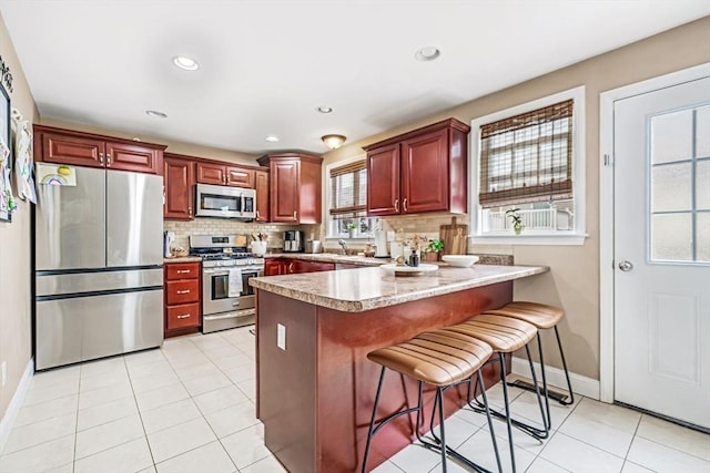 40 Winchester Ln Unit 10, Fall River, MA 02721 - kitchen with stainless steel appliances, a peninsula, tasteful backsplash, baseboards, and recessed lighting