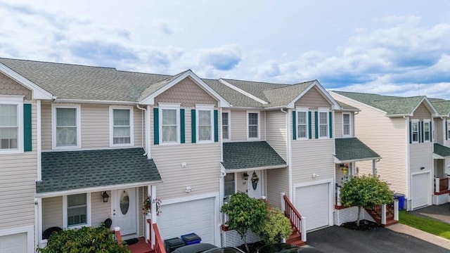 40 Winchester Ln Unit 10, Fall River, MA 02721 - view of property featuring driveway, an attached garage, and a shingled roof
