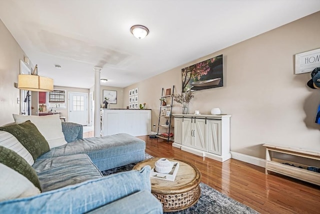 40 Winchester Ln Unit 10, Fall River, MA 02721 - living area featuring ornate columns, wood finished floors, and baseboards