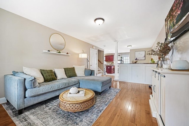 40 Winchester Ln Unit 10, Fall River, MA 02721 - living area with decorative columns, light wood finished floors, and stairs