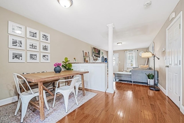 40 Winchester Ln Unit 10, Fall River, MA 02721 - dining room featuring ornate columns, light wood-type flooring, and baseboards