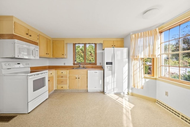 kitchen with white appliances, light brown cabinets, a baseboard heating unit, and a sink