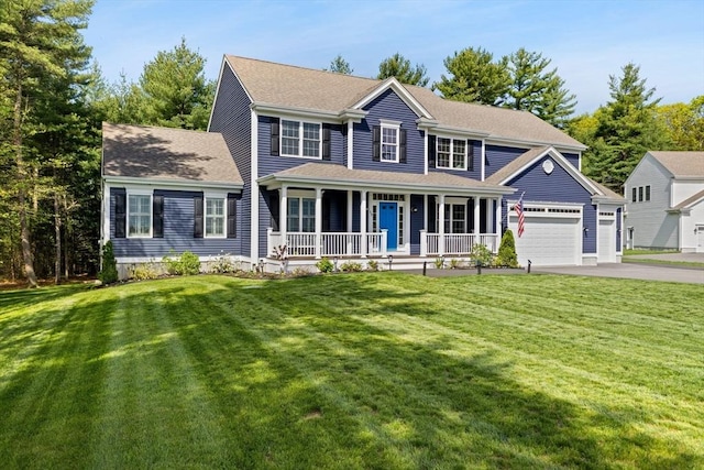 colonial home with a porch, driveway, a garage, and a front lawn